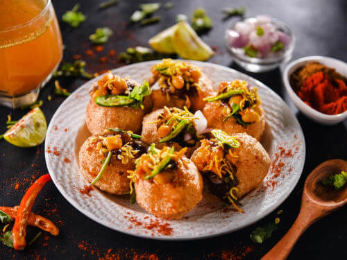 Chat is traditionally prepared using crisp fried dough wafers known as papdi and boiled chickpeas. The boiled potatoes, dahi (yogurt), and tamarind chutney topped with chat masala and sev.