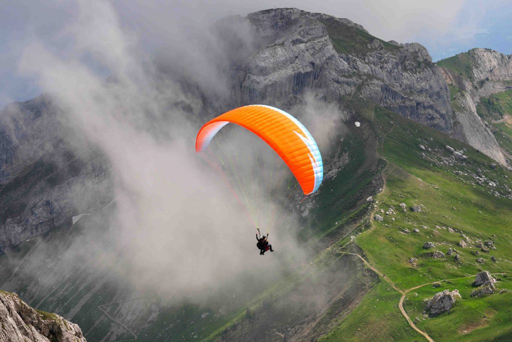 Paragliding is basically a blend of parachuting and gliding in which a person starts gliding after getting enough momentum while running down a slope